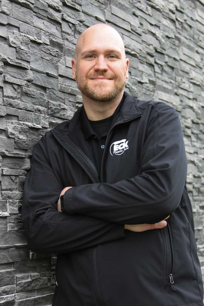 image of don loomis leaning against a stone wall